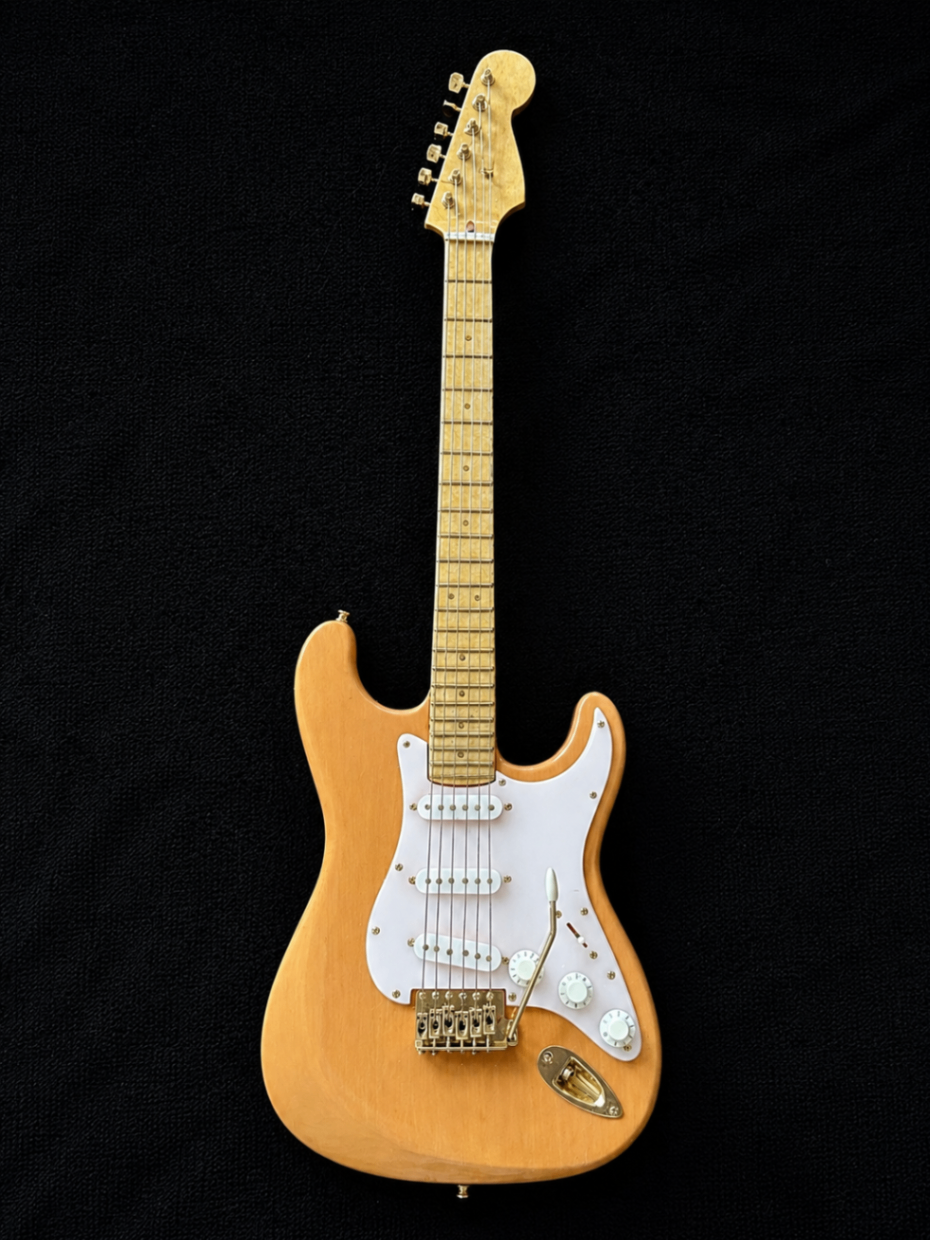 Handcrafted miniature Fender Stratocaster in Mary Kay soft pink with white plastic pickguard and solid 14K gold hardware by Rob Gwynne