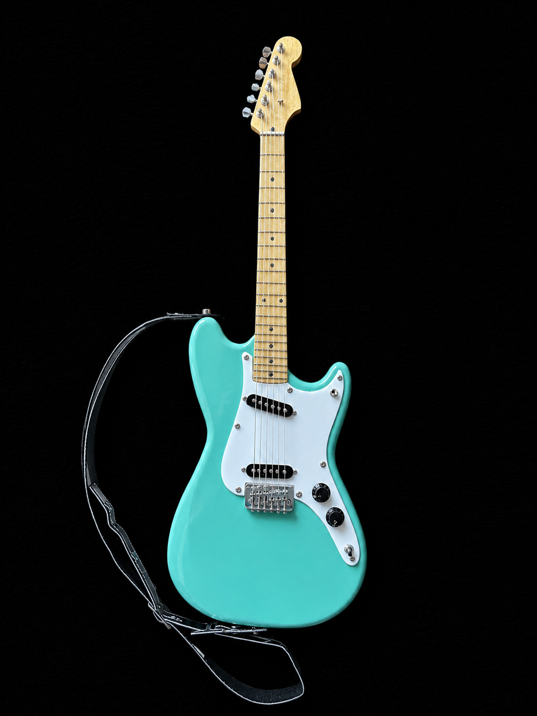 Handcrafted miniature Fender Mustang Duo-Sonic in seafoam green with white pickguard and imitation plastic strap by Rob Gwynne