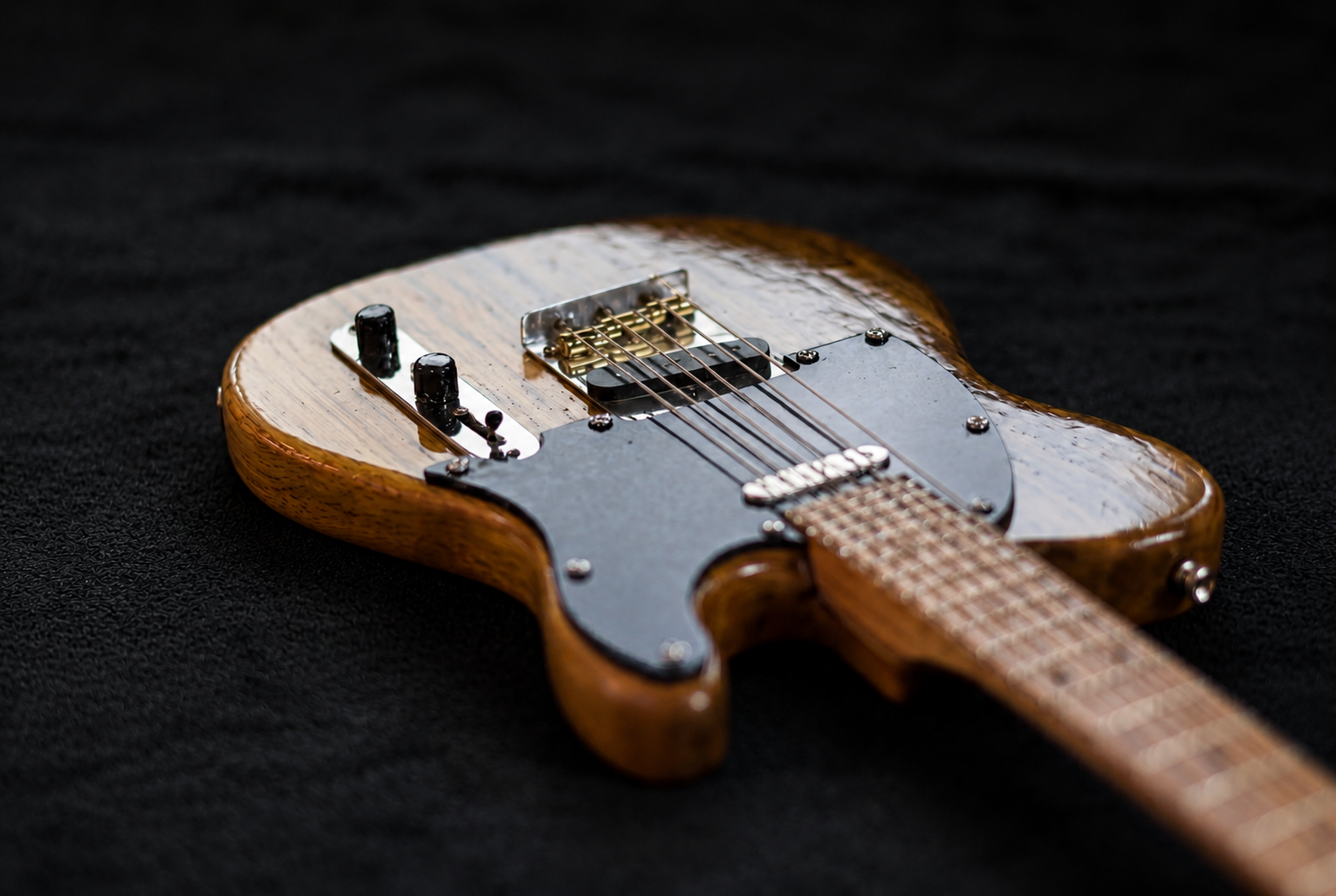 Top-down view of the miniature Telecaster body showing the California hardwood grain and hardware
